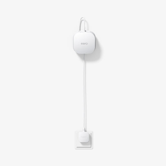 AMP09409 - Eero 6 Mount | ER110 in White showing the front and partial top installed and plugged in