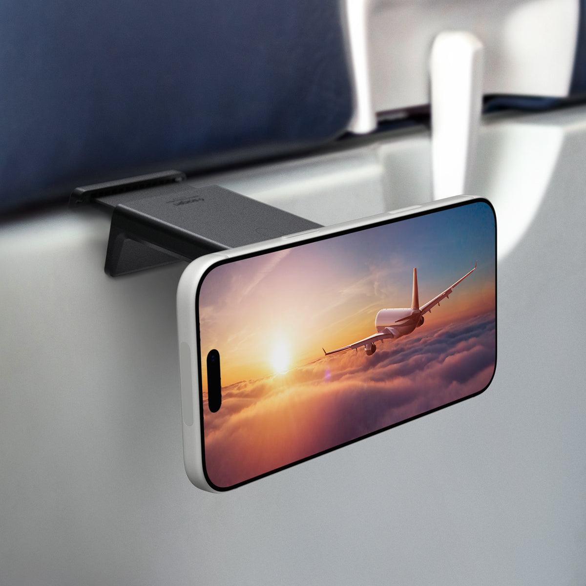 AMP05756 - In-flight Phone Mount (MagFit) in black showing the mount on the airplane tray with iPhone attached