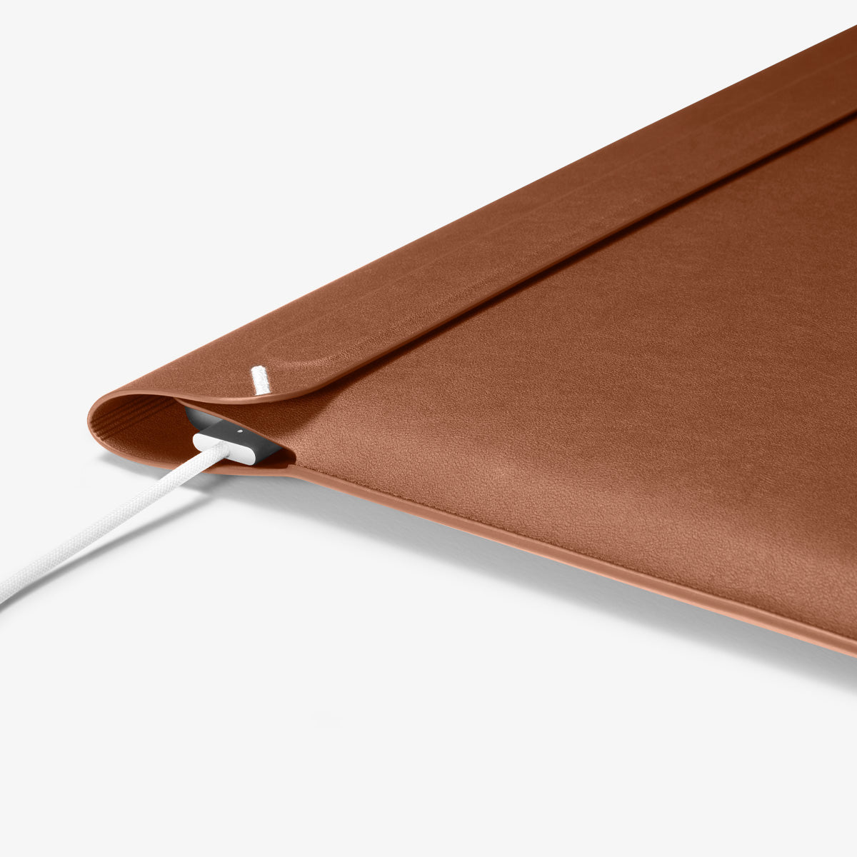 AFA06419 - MacBook Pro 16-inch Valentinus Laptop Pouch in Classic Brown side profile showing slim leather design with device inside and charger connected