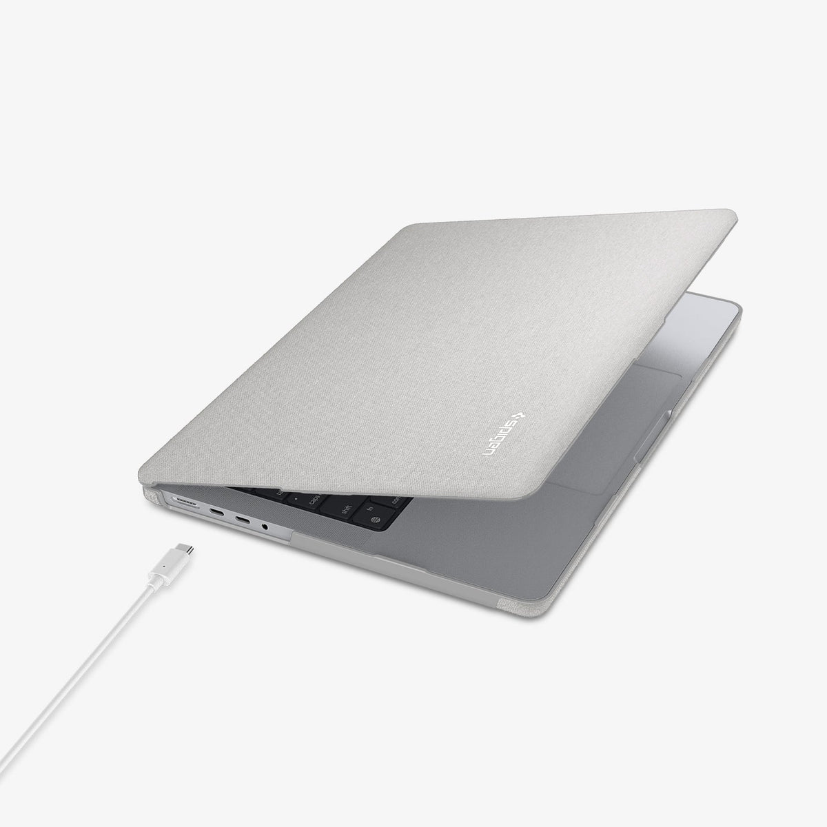 ACS10976 - MacBook Pro 14-inch in Heather Gray showing the top and side with laptop slightly open and charging cable next to port