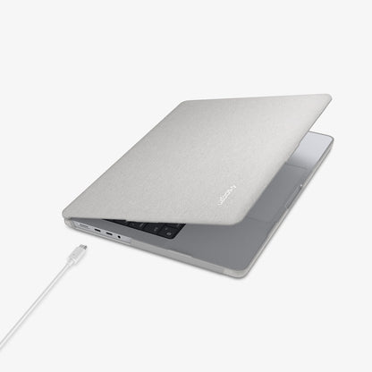 ACS10976 - MacBook Pro 14-inch in Heather Gray showing the top and side with laptop slightly open and charging cable next to port