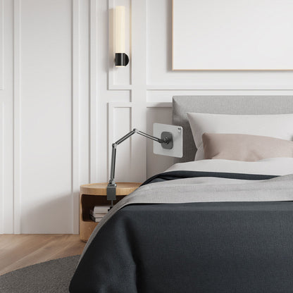 AMP09191 - OneTap Clamp in Space Gray showing the clamp stand with the device attached, clamped to a night stand beside the bed