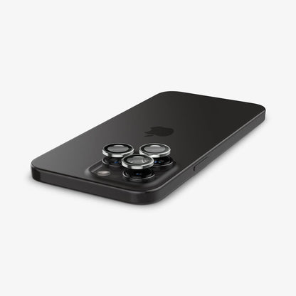 AGL05599 - iPhone 15 Pro / 15 Pro Max Optik Pro Lens Protector in silver showing the back with lens protector hovering above the camera lens