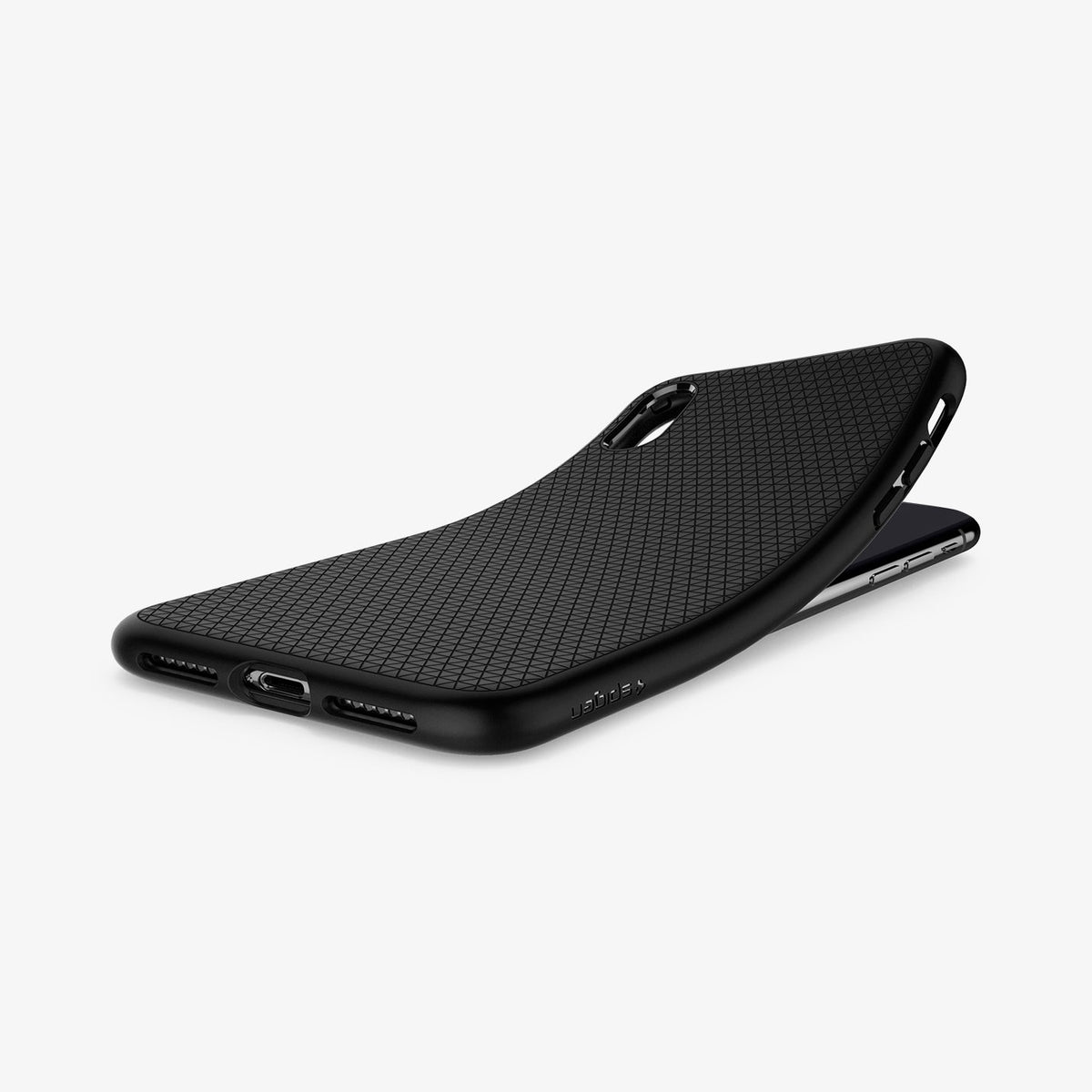 057CS22123 - iPhone XS Case Liquid Air in Matte Black showing the back, partially peeled from behind a device on a flat surface