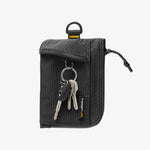 AFA11229 - Soft Card Holder | LF300 in Black showing front view with mesh pocket exterior displaying a car key fob and two metal keys on a keyring, zipper closure with pull tab, D-ring attachment loop at top, and diamond-pattern ripstop fabric upper panel with Spigen Life branding label.