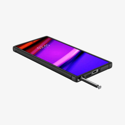 ACS07286 - Galaxy S24 Ultra Case Rugged Armor in Matte Black showing the front, partial side and bottom with stylus pen sticking out from a device on a flat surface