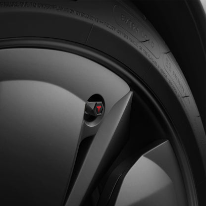 ACP11371 - Universal Tire Valve Stem Cap | VS100TS/R in Red showing the matte black hexagonal cap with red Tesla logo installed on a vehicle wheel.