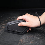 ACP11829 - Hand holding the Spigen car detailing scraper over a surface covered in pet hair